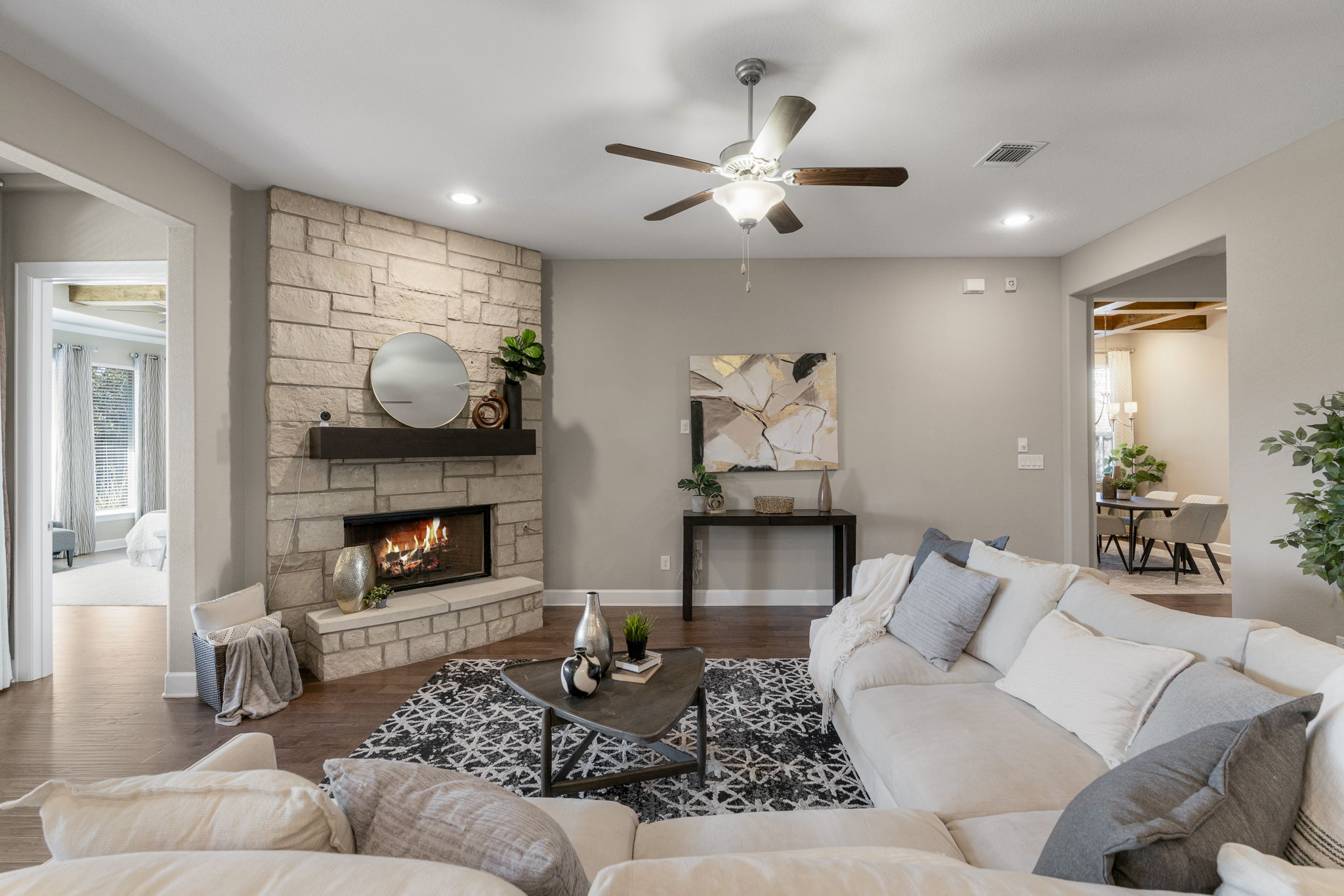 110 Topaz Circle Dripping Springs, TX 78620 - Photo 10 of 40 The living room offers ample space for gathering with friends and family in front of the striking wood-burning fireplace framed in a stone hearth with a wood mantel.