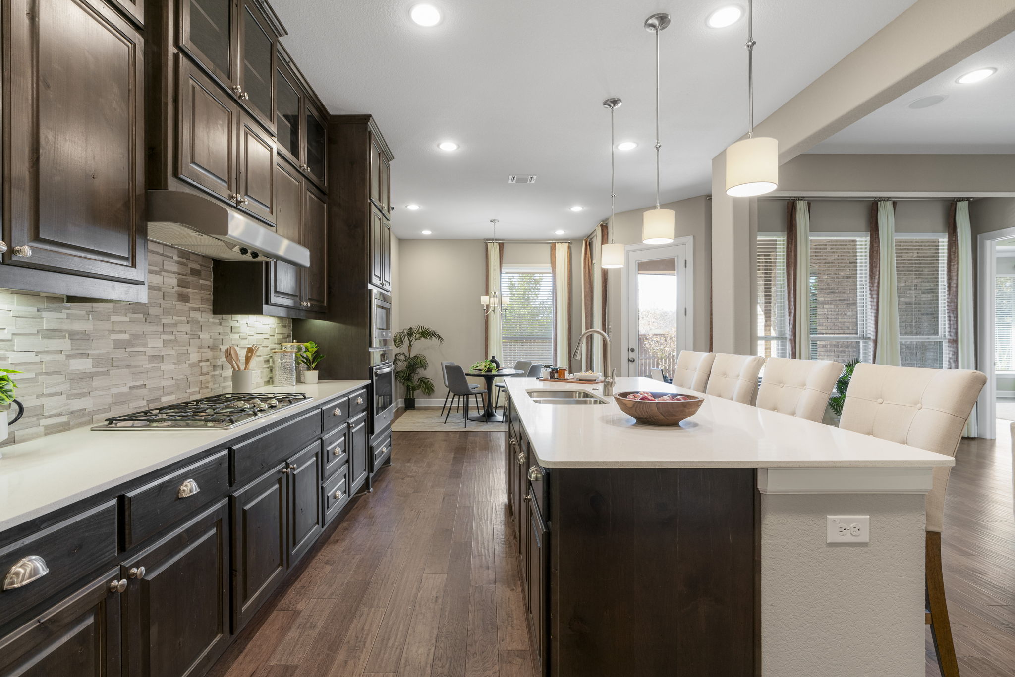 110 Topaz Circle Dripping Springs, TX 78620 - Photo 15 of 40 Built-in stainless appliances include a wall oven and microwave, dishwasher, and gas cooktop with vent hood.