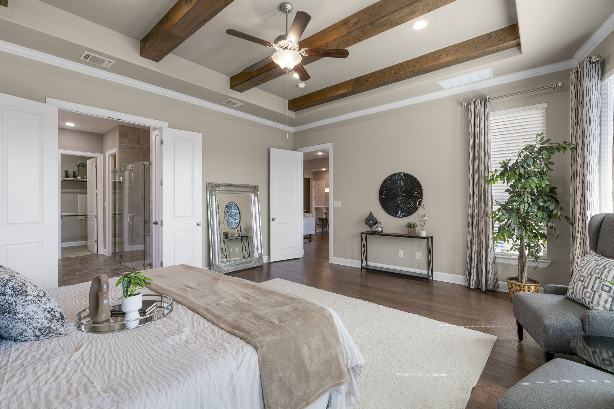 110 Topaz Circle Dripping Springs, TX 78620 - Photo 20 of 40 The secluded primary suite is an oversized retreat secluded away at the back of the home overlooking the backyard through a wall of bay windows.