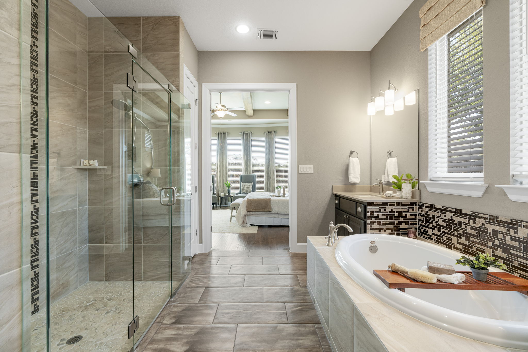 110 Topaz Circle Dripping Springs, TX 78620 - Photo 22 of 40 Relax in the built-in soaking tub and enjoy a large frameless glass enclosed shower with river-rock tile, plus a walk-in closet and private toilet.
