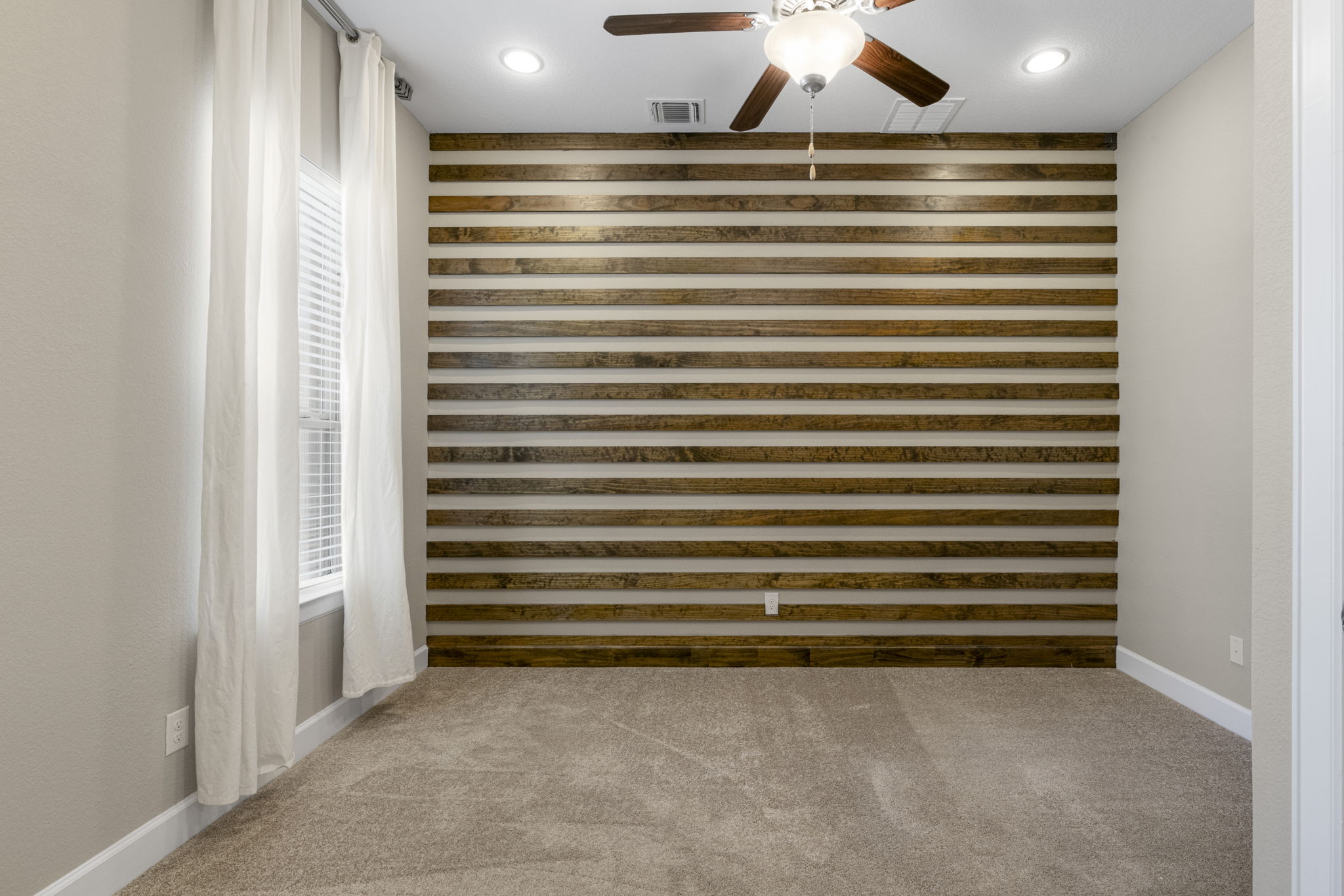 110 Topaz Circle Dripping Springs, TX 78620 - Photo 26 of 40 One of three secondary bedrooms this room is secluded away at the front of the home in the hallway to the single car garage and comes with its own ensuite bath.