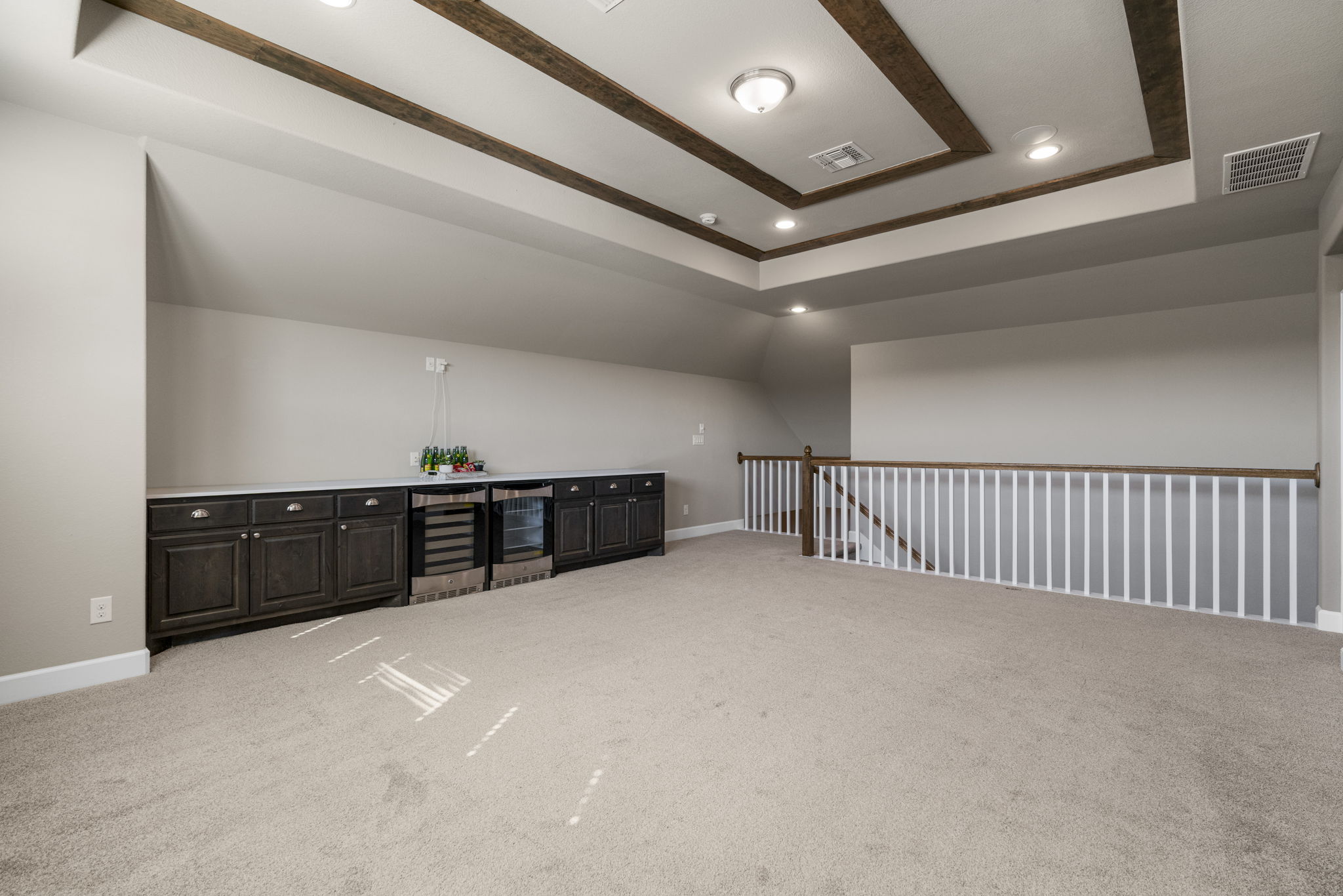 110 Topaz Circle Dripping Springs, TX 78620 - Photo 32 of 40 Upstairs you will find this awesome bonus living area perfect for entertaining with a built-in dry bar that comes with two beverage fridges.