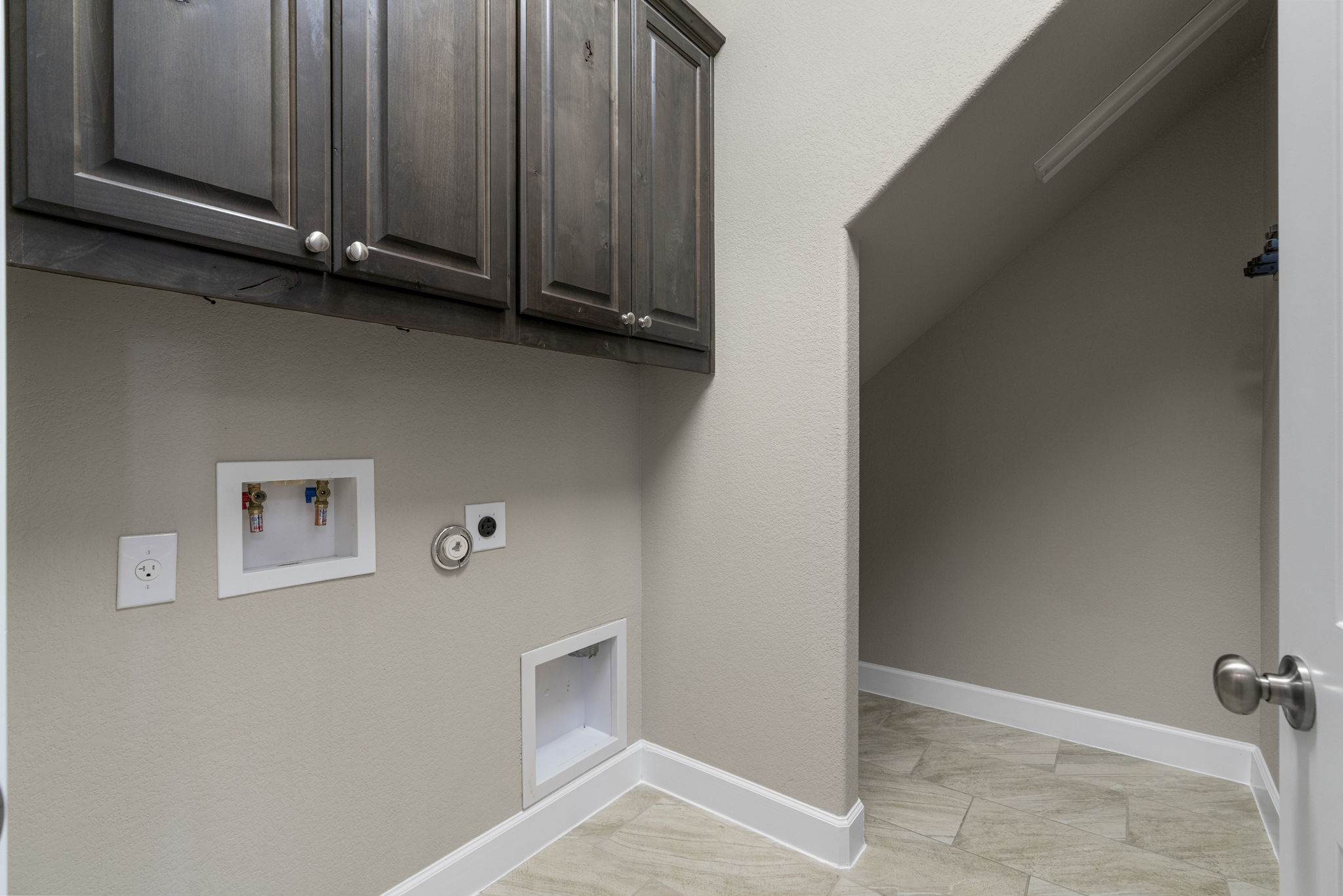 110 Topaz Circle Dripping Springs, TX 78620 - Photo 35 of 40 The main floor laundry room is situated in front of the mud room entry off the two car garage.