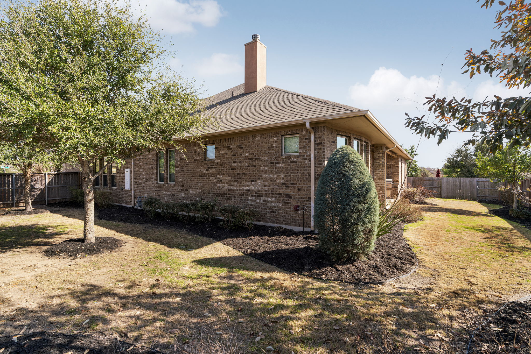 110 Topaz Circle Dripping Springs, TX 78620 - Photo 37 of 40 A private fenced yard wraps around the home offering ample space to play and grow.