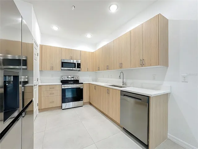 a sink sitting area with wooden cabinets