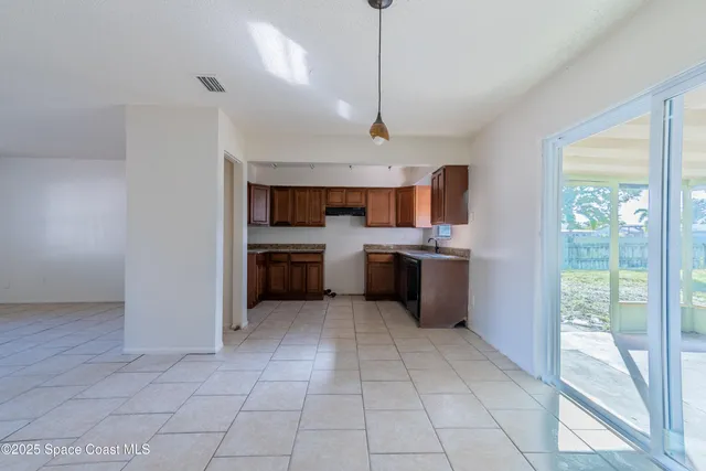 a large kitchen with a large counter top stainless steel appliances and cabinets