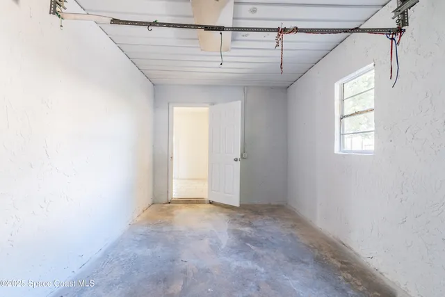 a view of a livingroom with an empty space and a window