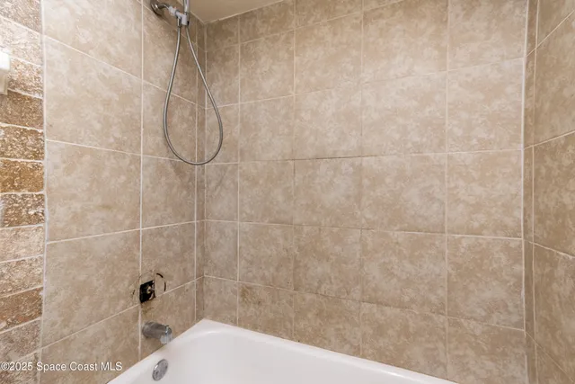 a bedroom with a bed and large window