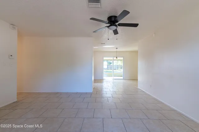 a view of a livingroom with a ceiling fan and window