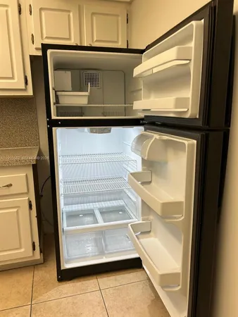 a view of a room with an empty space and a window