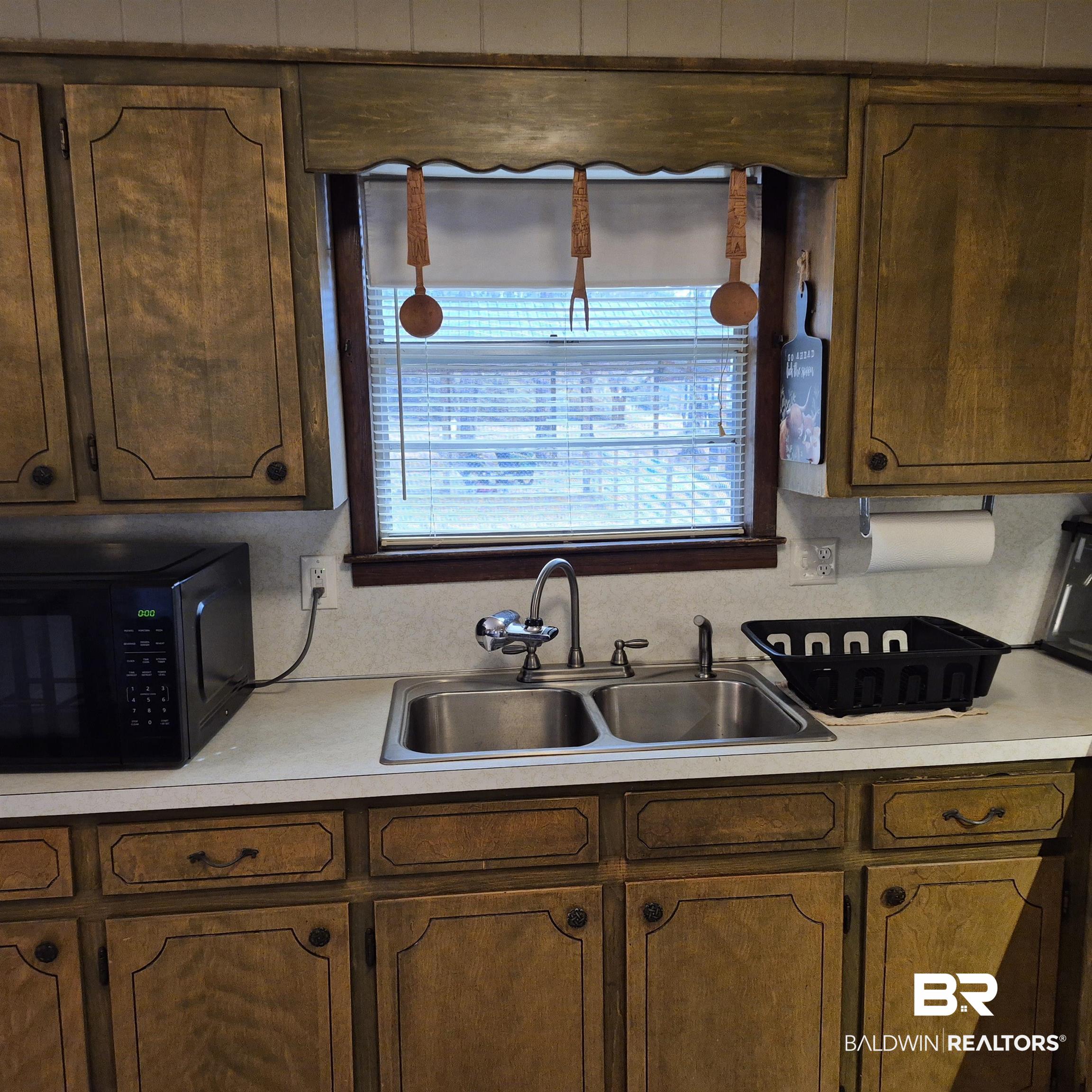 491 Forrest Avenue Castleberry, AL 36432 - Photo 10 of 33 Kitchen with light countertops and black microwave