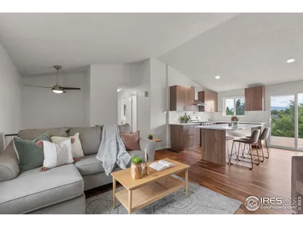 a living room with furniture and kitchen view