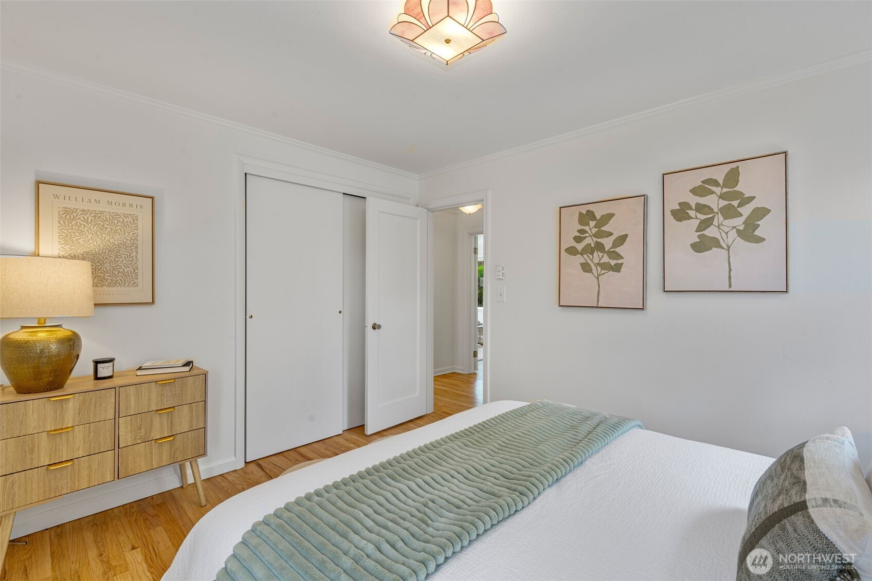 8115 34th Avenue Southwest Seattle, WA 98126 - Photo 12 of 39 a bedroom with a bed and painting on the wall