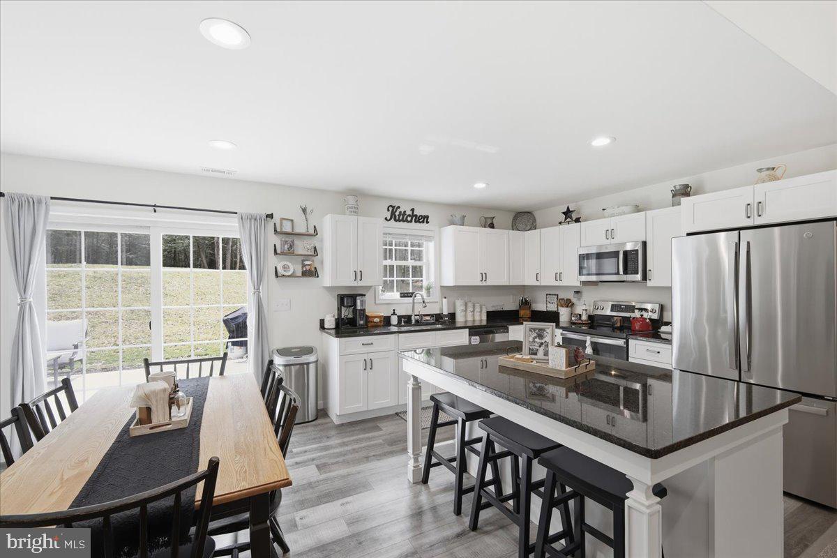 85 McCool Lane Lehighton, PA 18235 - Photo 15 of 39 a kitchen with granite countertop a table chairs stove and refrigerator