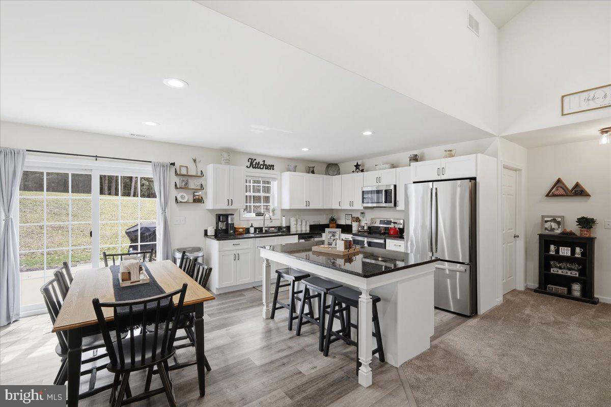 85 McCool Lane Lehighton, PA 18235 - Photo 31 of 39 a kitchen with stainless steel appliances a table chairs and a refrigerator
