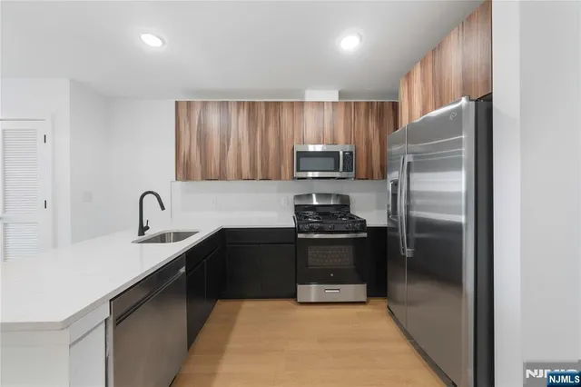 a kitchen with a refrigerator sink and stainless steel appliances