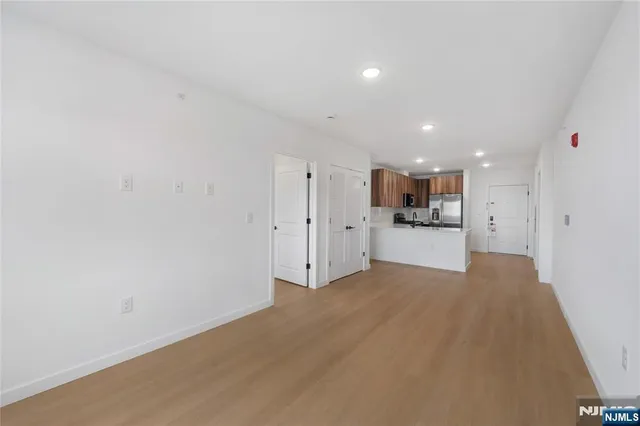 a view of a kitchen with a sink and a refrigerator
