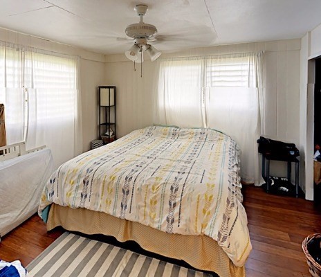 372 Pua Road Kapaa, HI 96746 - Photo 12 of 20 a bed sitting in a spacious bedroom next to a window and a chandelier