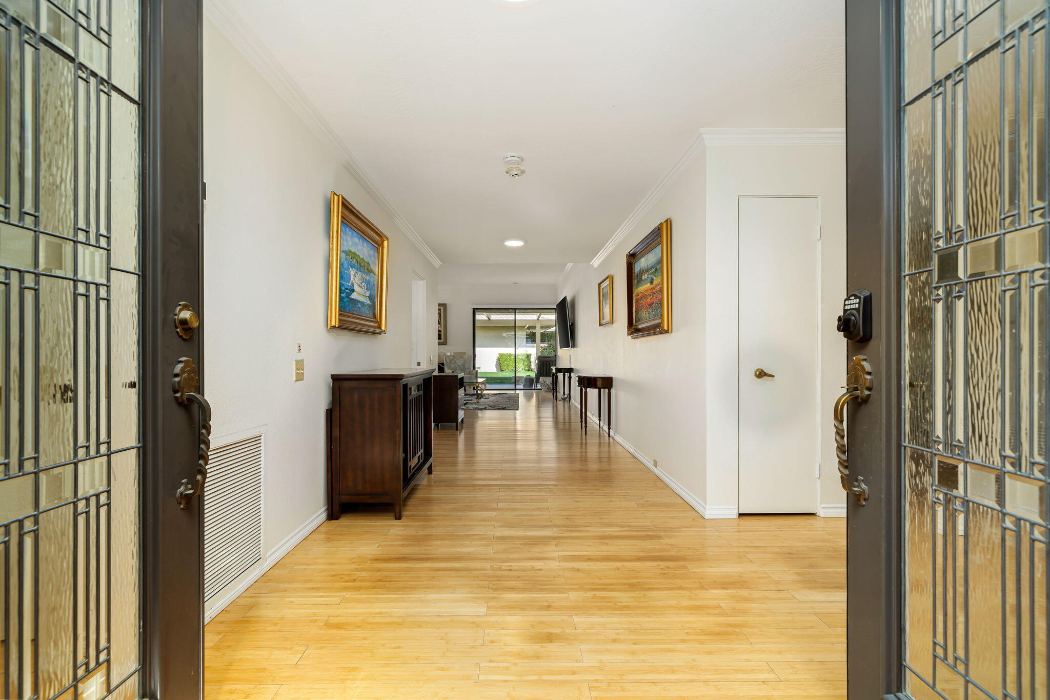 1 Rutgers Court Rancho Mirage, CA 92270 - Photo 1 of 37 a view of a hallway with wooden floor and a living room
