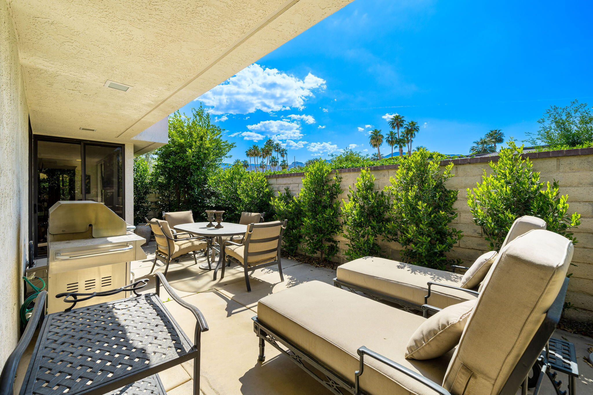 1 Rutgers Court Rancho Mirage, CA 92270 - Photo 14 of 37 a view of a patio with couches table and chairs and potted plants
