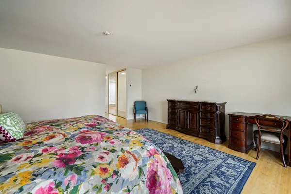a bedroom with a bed and a dresser in it