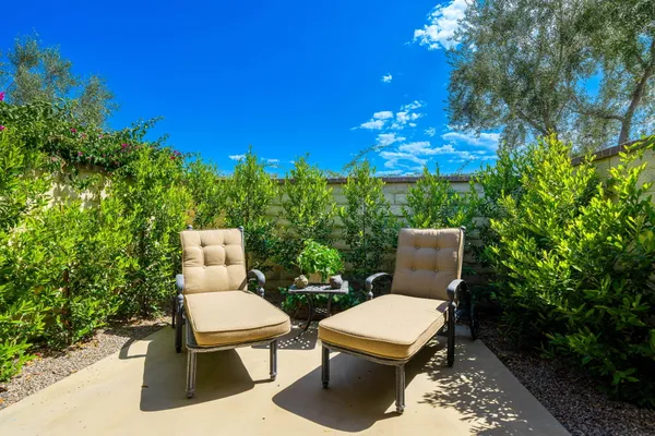 a view of a patio with table and chairs and potted plants