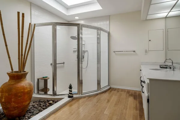 a bathroom with a granite countertop sink and a mirror