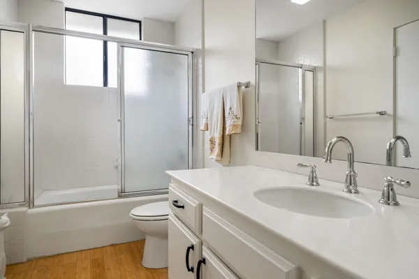 a bathroom with a sink toilet and shower