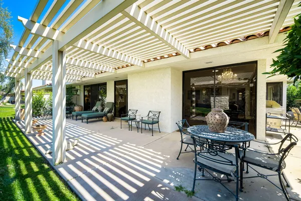 a view of a patio with table and chairs and potted plants