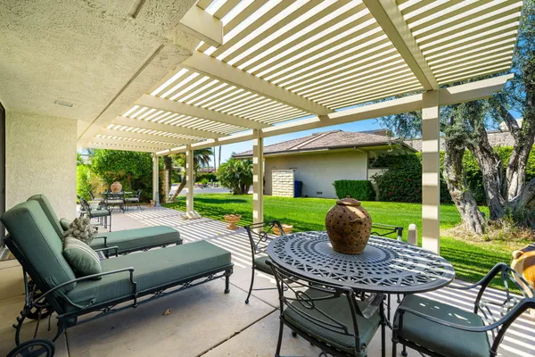 a view of a patio with a table and chairs