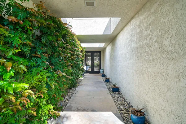 view of a pathway both side of house