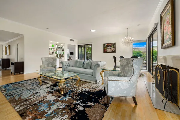 a living room with fireplace furniture and a wooden floor