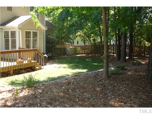 9105 Doublebit Drive Raleigh, NC 27615 - Photo 11 of 20 Lovely backyard bordered with stacked stone, totally fenced and a nice mixture of wooded area with open area.