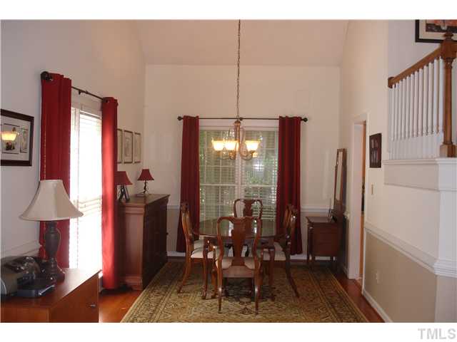 9105 Doublebit Drive Raleigh, NC 27615 - Photo 5 of 20 Formal dining room with hardwood floors, chair rail and a new chandelier.
