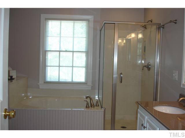9105 Doublebit Drive Raleigh, NC 27615 - Photo 7 of 20 This is a terrific bathroom renovation! All new fixtures, faucets, shower surround, new tile floor, solid surface countertops, double sinks, garden tub and a separate water closet.