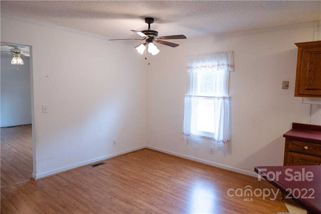 5040 Tabernacle Road Lancaster, SC 29720 - Photo 11 of 26 a view of empty room with wooden floor and fan