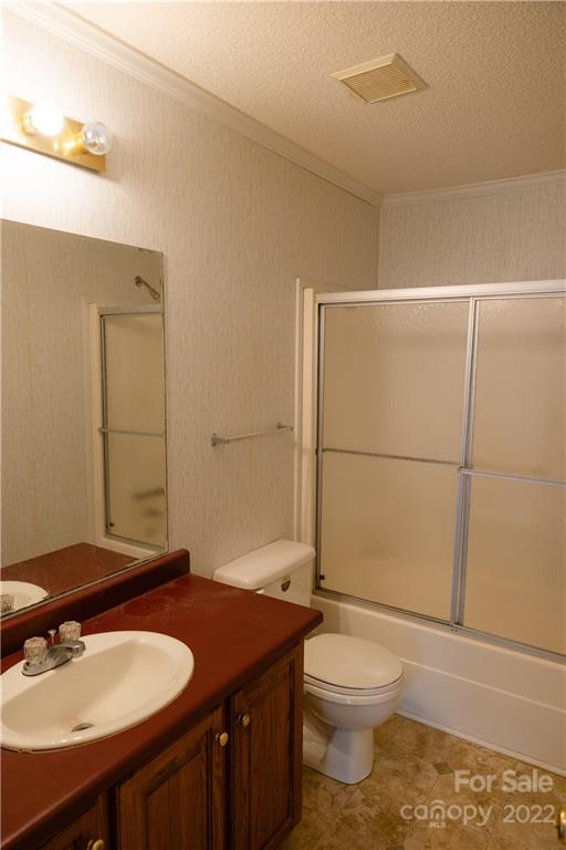 5040 Tabernacle Road Lancaster, SC 29720 - Photo 18 of 26 a bathroom with a granite countertop sink toilet a mirror and shower