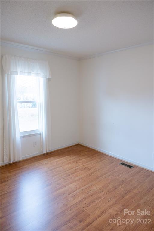 5040 Tabernacle Road Lancaster, SC 29720 - Photo 19 of 26 an empty room with wooden floor and windows