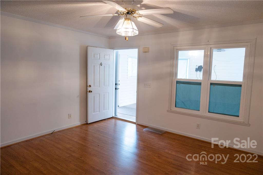 5040 Tabernacle Road Lancaster, SC 29720 - Photo 23 of 26 a view of an empty room with wooden floor and a window