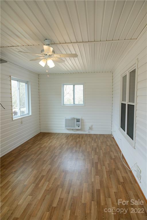 5040 Tabernacle Road Lancaster, SC 29720 - Photo 3 of 26 an empty room with wooden floor fan and windows