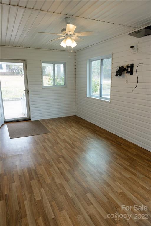 5040 Tabernacle Road Lancaster, SC 29720 - Photo 4 of 26 an empty room with wooden floor chandelier fan and windows
