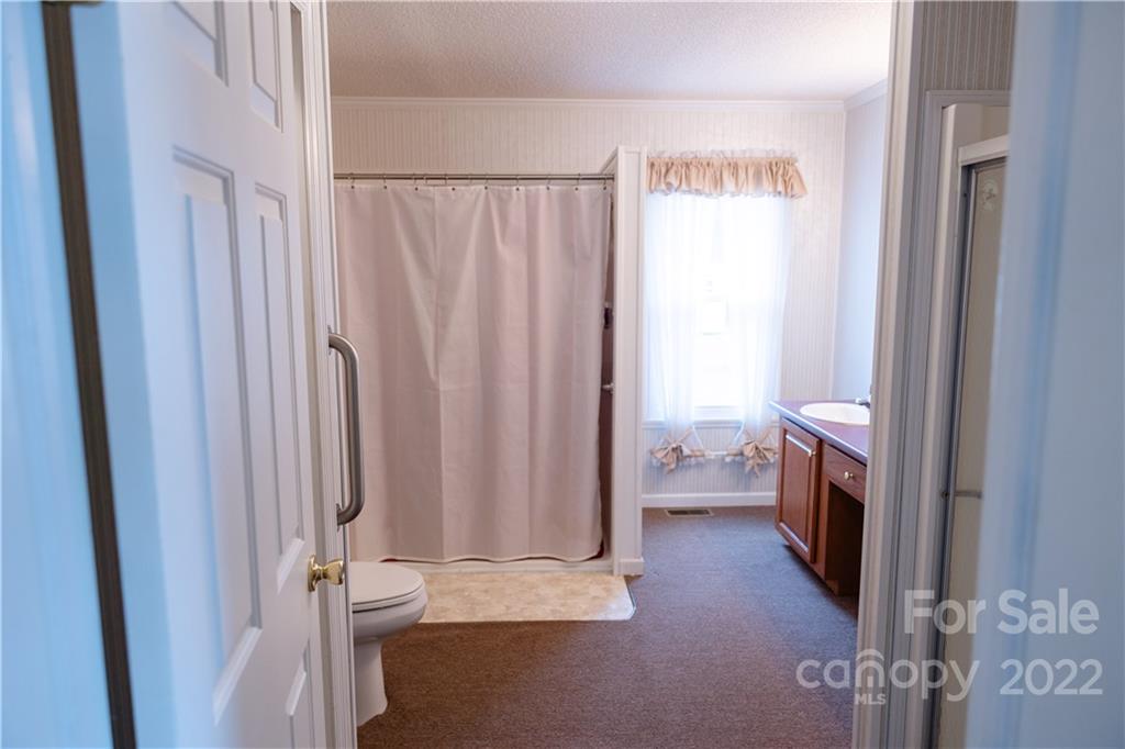 5040 Tabernacle Road Lancaster, SC 29720 - Photo 8 of 26 a bathroom with a sink a toilet and shower