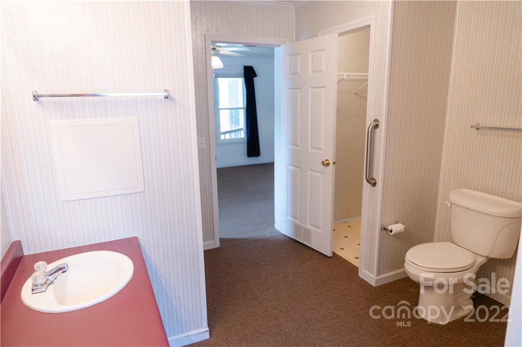 5040 Tabernacle Road Lancaster, SC 29720 - Photo 10 of 26 a bathroom with a toilet and a sink