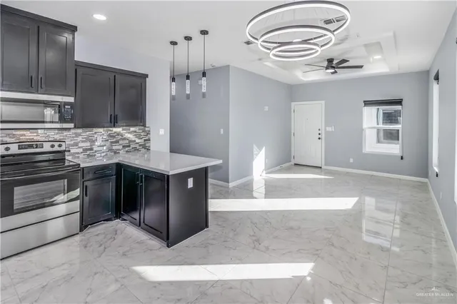 a kitchen with stainless steel appliances granite countertop a stove and a sink