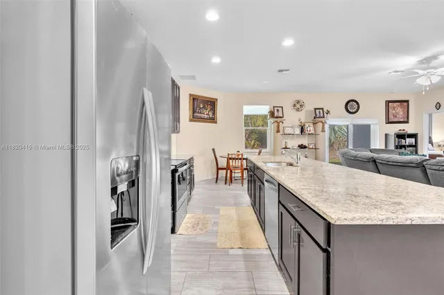 a kitchen with a sink cabinets and wooden floor