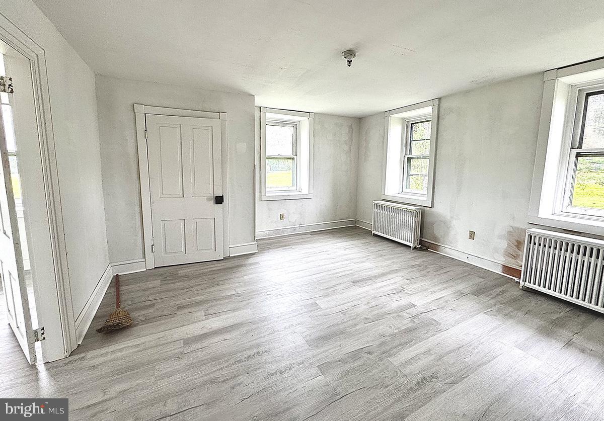 133 Hunter Road Oley, PA 19547 - Photo 19 of 44 an empty room with wooden floor and windows
