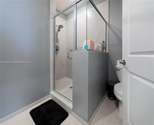 a view of a kitchen with kitchen island a sink wooden floor and a counter top space