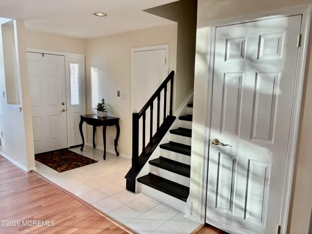 a view of entryway and hall with wooden floor