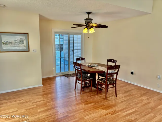 a view of a dining room with furniture and a chandelier
