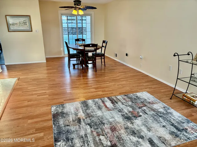 a view of a dining room with furniture window and wooden floor